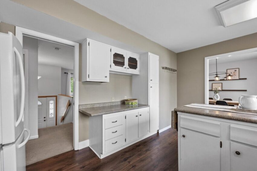 Kitchen with tall pantry and built in desk counter overhang,