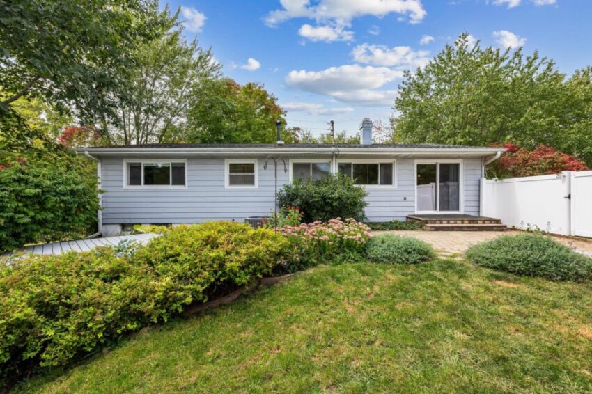 Back of house with landscaping and stoop.