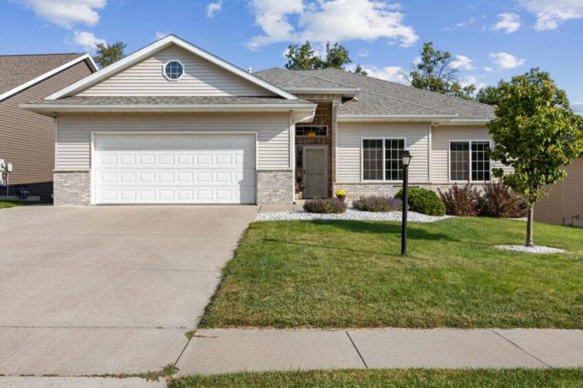 Ranch home in Coralville with two car garage and concrete drive.