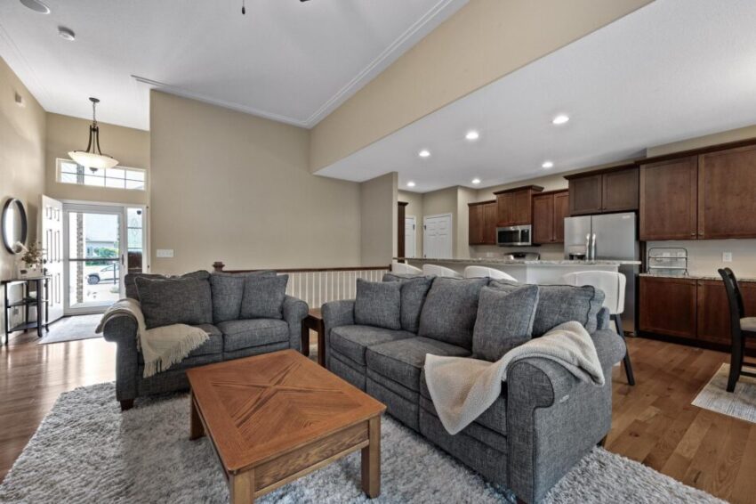 Living room of open-concept space with kitchen beyond.