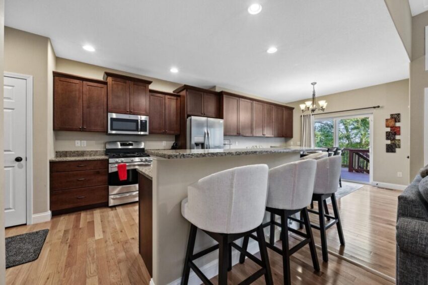 Kitchen with hardwood floors and stainless steel appliances.