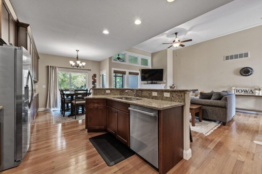 Kitchen with dark wood cabinets and sink and dishwasher in free standing counter.