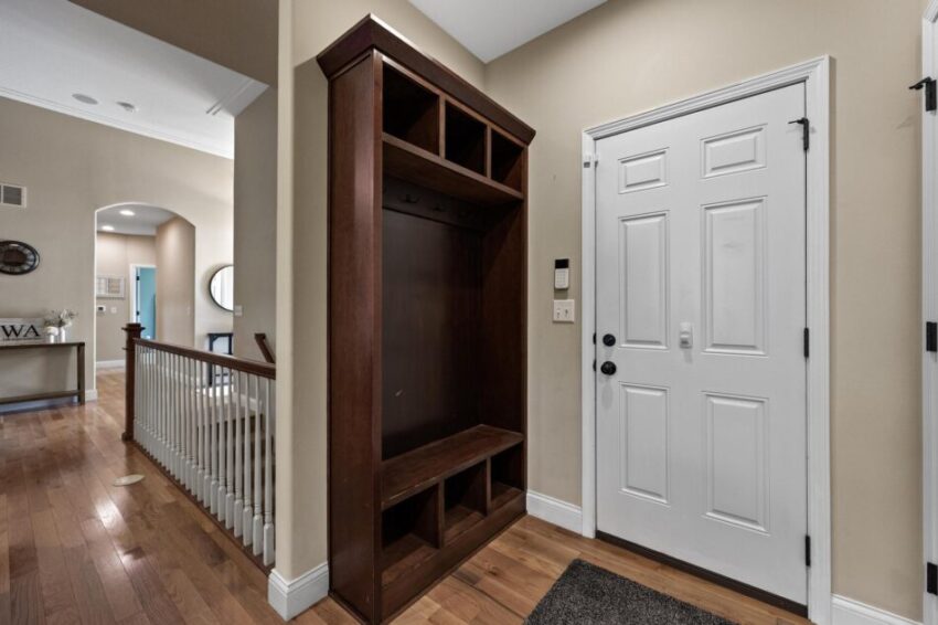 Front door with built in cabinet for jacket and shoe storage.