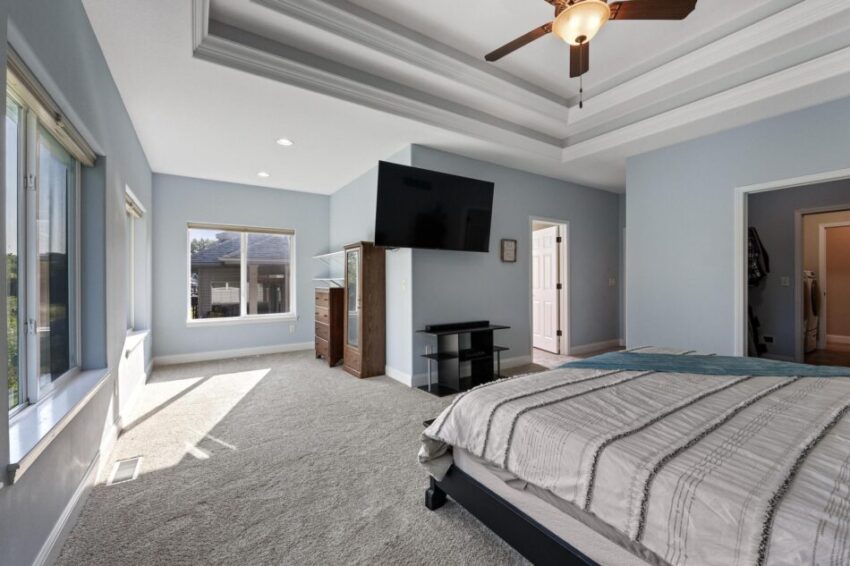 Primary bedroom, with light blue walls and white trim.