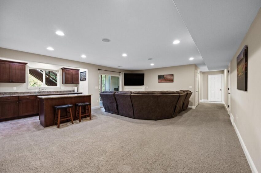 Lower level with wall-to-wall carpet and ceiling lighting.