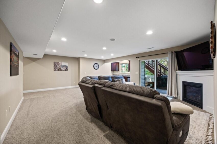 Lower level entertainment area with fireplace and sliding doors.