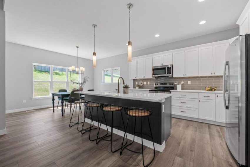 Kitchen with seating at dark gray island.