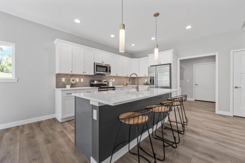 Kitchen with modern vinyl floors and sink in island.