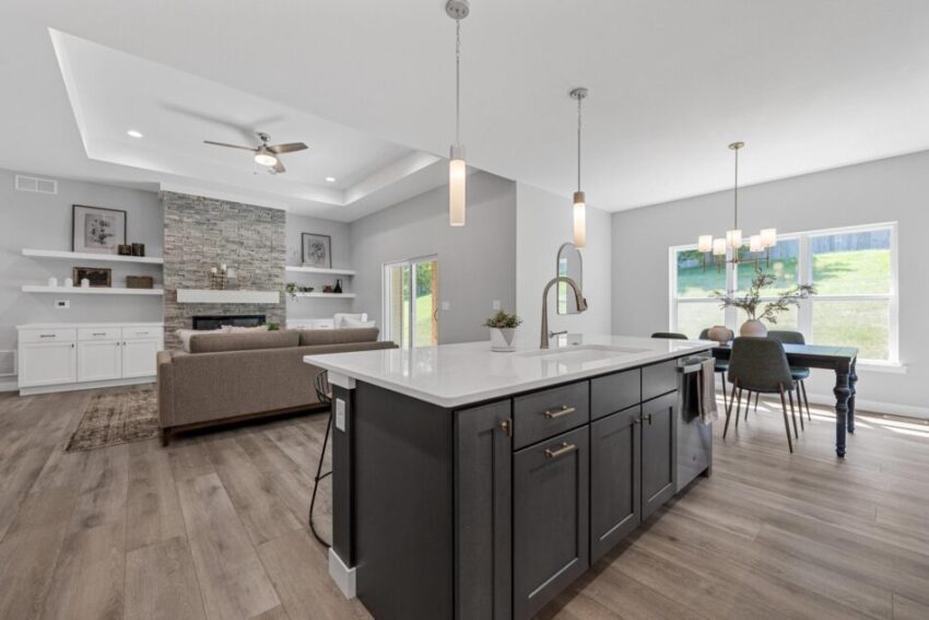 Kitchen with living room and dining area beyond.