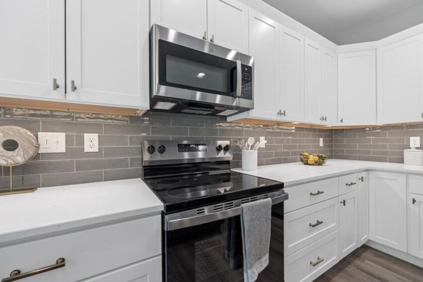 Kitchen with stainless stove and microwave above.