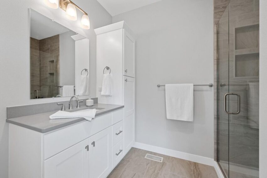 Bathroom 1, with gray counter, white cabinet, and tile floor.