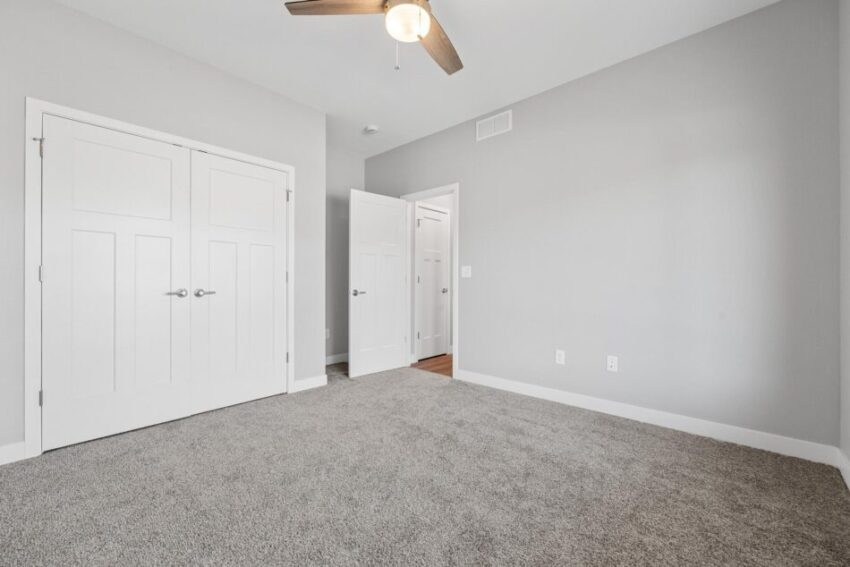 Bedroom 3, with ceiling fan, light gray walls, and wall-to-wall carpet.