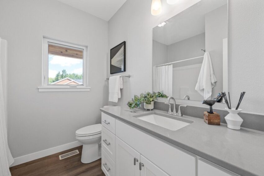 Bathroom 2, with gray countertop, white cabinets, and white trim.