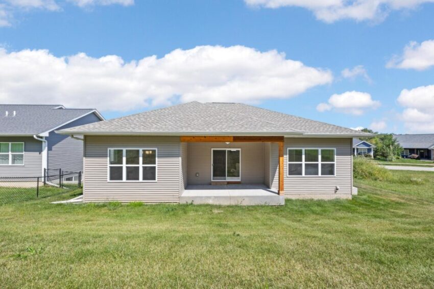 Back of house with porch exit and wood pillar.