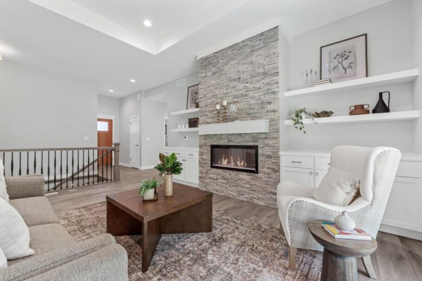 Spacious living room with white built-in shelves and cabinets.