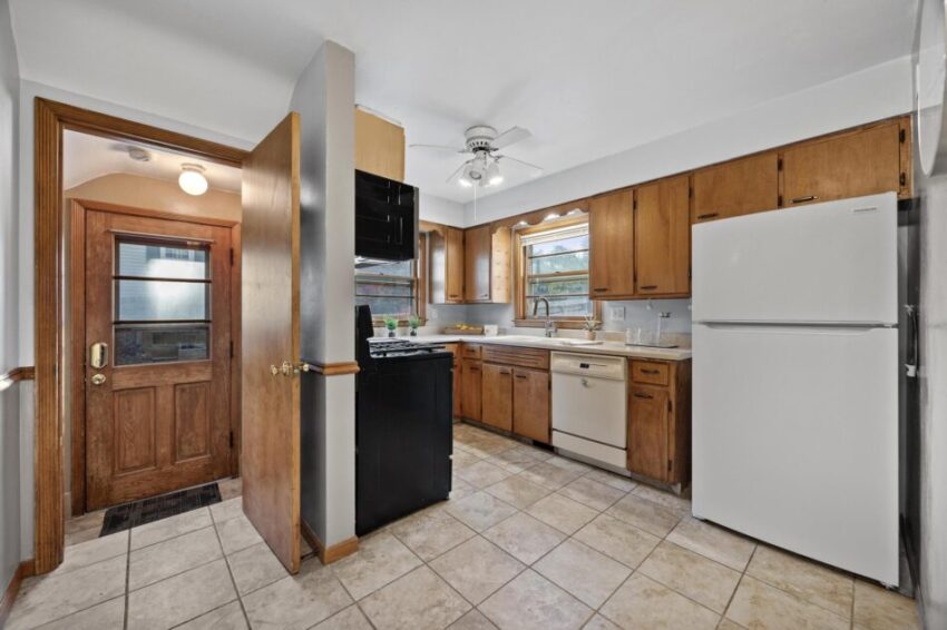 Kitchen with wood cabinets and tile floor.