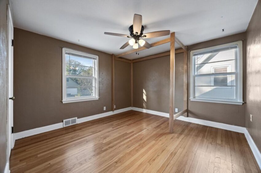 Bedroom 3, with ceiling fan and beige walls.