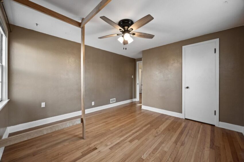 Bedroom 3, with white trim and hardwood floors.