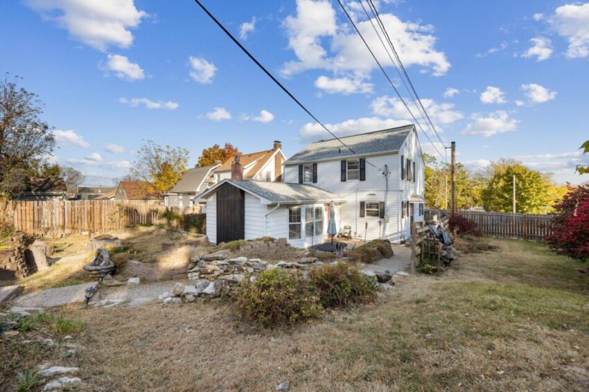 Landscaped backyard with shrubs and lawn.