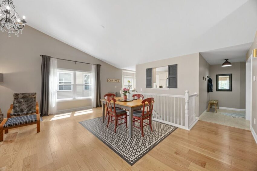 Open living room with dining area, wooden floors, and natural light.