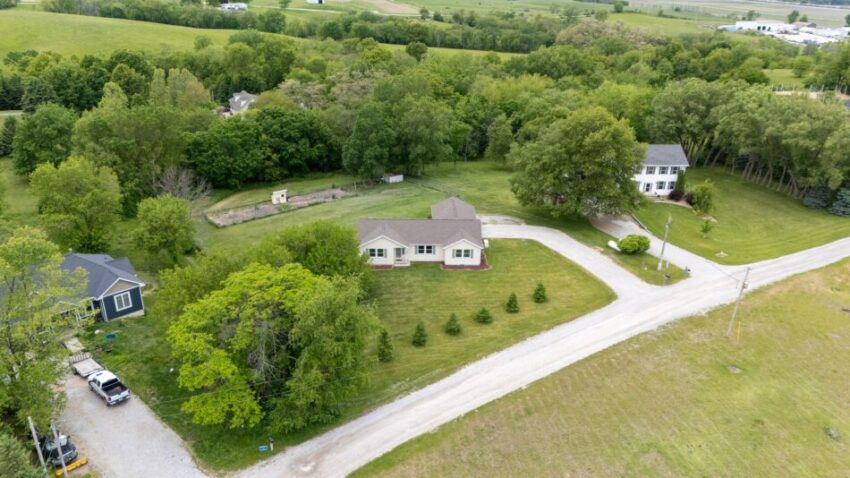 Aerial view of a house with a large backyard and garden.