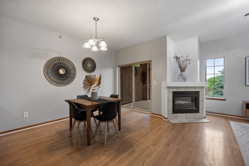 Dining area with table, chairs, wall decor, and fireplace.