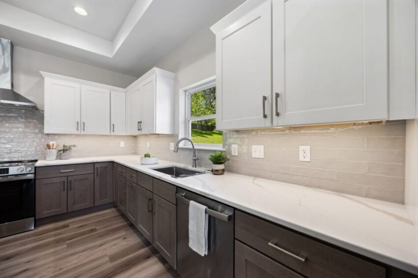 Modern kitchen with island, backsplash, and stainless steel appliances.