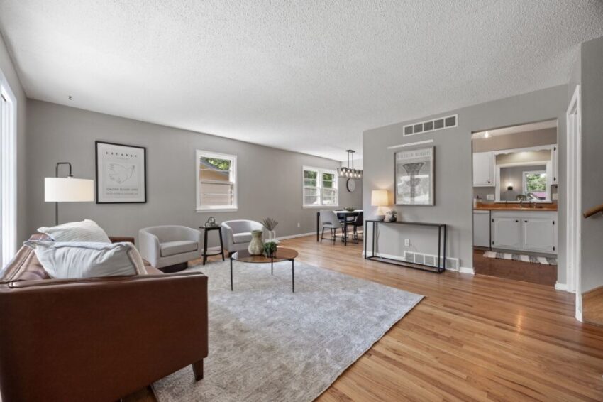 Spacious living room with modern furniture and hardwood floors.