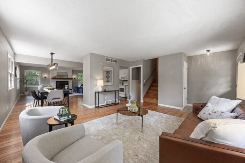 Spacious living room with modern furniture and wooden flooring.